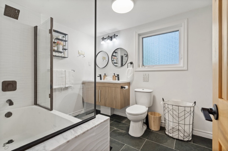 Main bathroom with double sink vanity and slate floor